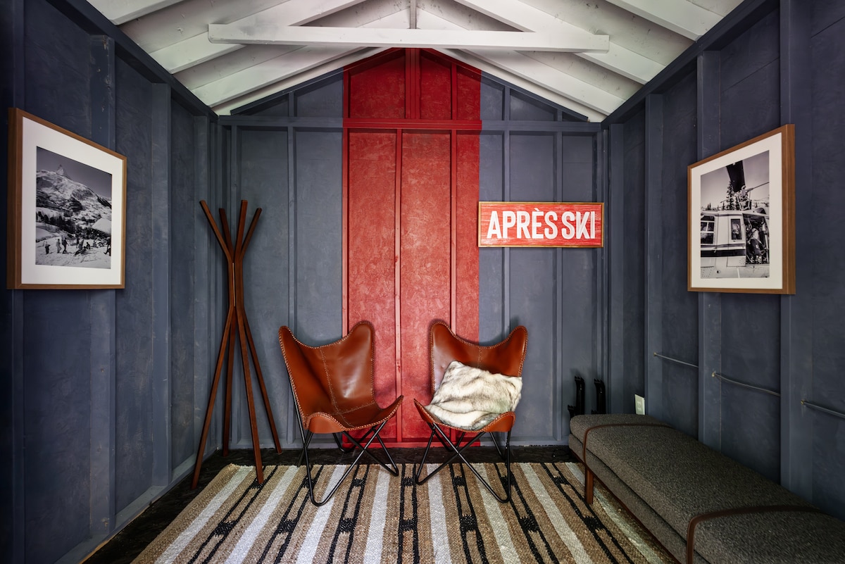 The ski gear drop zone at Raccoon Chalet, with chairs and mountain photographs
